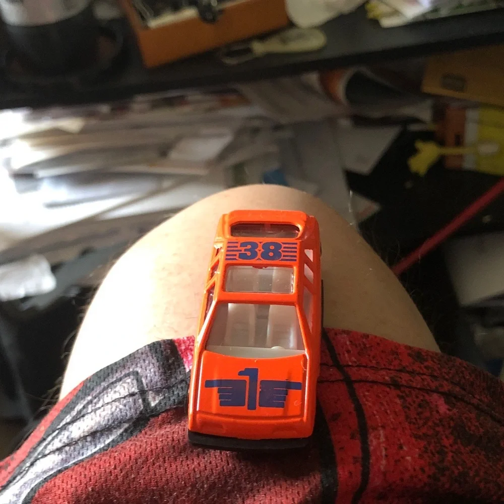 Orange Diecast Toy Race Car with Blue Number Graphics